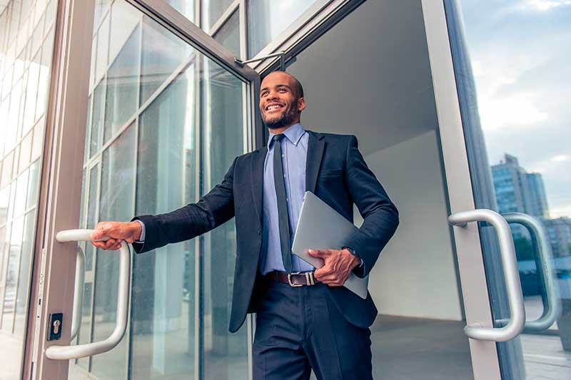 Businessman Exiting Office Through Commercial Door